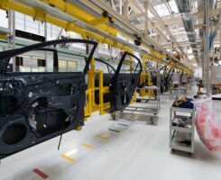 car door on conveyor. Robotic equipment makes Assembly of car. Modern car Assembly at factory