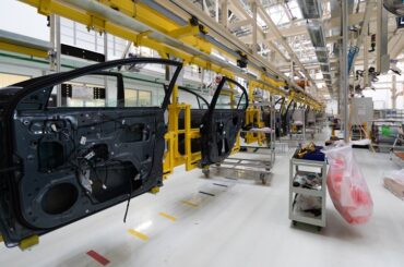 car door on conveyor. Robotic equipment makes Assembly of car. Modern car Assembly at factory